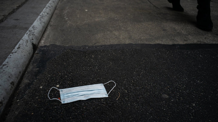 Illustrative photo of a discarded mask on the ground